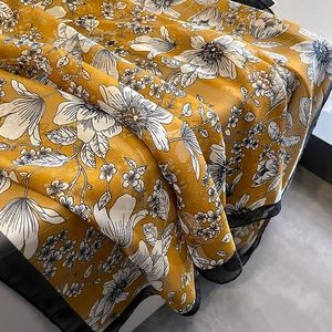 Elegant mustard yellow floral silk scarf with black piping edges for beach sun protection