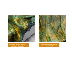 Detail of green silk scarf with golden floral patterns and reinforced hem stitching