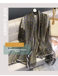 Floral chiffon beach shawl and sun protection scarf on a stylish white leather sofa