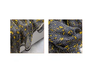 Detail of floral chiffon scarf showing digital print quality and reinforced stitched edges