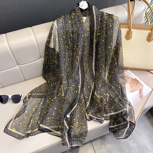 Elegant long floral scarf for women featuring yellow and white flowers on black silk