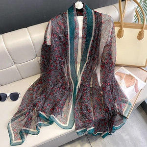 Floral chiffon scarf shawl in red and black pattern hung on a white minimalist hanger