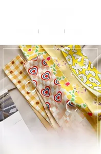 Detail of printed silk scarves showing smooth texture and various floral patterns