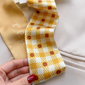 Detail of yellow double-sided silk scarf with floral checkerboard and I Love typography