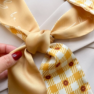 Close-up of silky floral printed skinny scarf with yellow houndstooth pattern detail