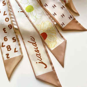 Fashionable long skinny silk scarf set in khaki and nude tones with daisy and H print