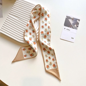 Detail of floral silk twilly scarf with champagne edges used as a decorative bag handle
