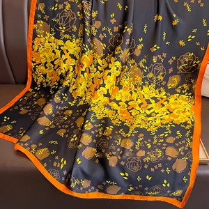 Floral print long silk-like scarf in black and orange with vibrant rose patterns