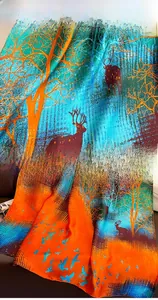 Detail of silk-feel scarf featuring elk patterns and vibrant forest landscape print