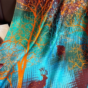 Elegant silk-like scarf featuring a vibrant elk and forest print on leather background