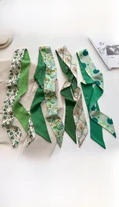 Detail of four green faux silk scarves with floral and leaf patterns, size 7x130cm