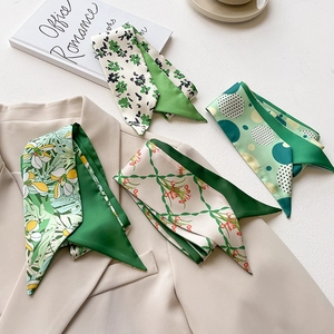 Selection of green French style narrow silk scarves with floral and geometric patterns