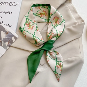 French style green floral silk scarf tied on a beige blazer collar for styling