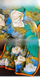 Detail view of lotus floral print silk scarf with high-quality orange hem and green silk fabric