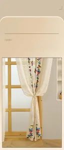 Detailed embroidery of colorful butterflies on beige floral lace curtains