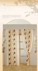 Close-up of semi-transparent lace curtain featuring ladybug and floral embroidery details
