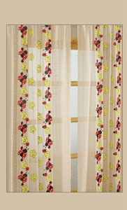 Detail of ladybug and flower embroidery on cream lace curtain with scalloped edges