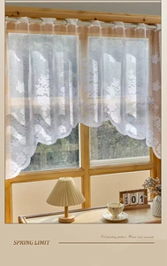 Close-up of white daisy lace cafe curtain with vintage floral mesh and scalloped hem