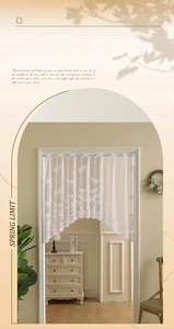 Detail of white daisy floral lace cafe curtain with delicate embroidery in sunlight