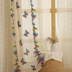White lace curtain with colorful butterfly embroidery and wavy scalloped edges