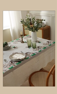Close-up of rustic table runner with mushroom embroidery and white lace edges