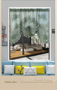 Close-up of light green lace partition curtain with intricate floral crochet patterns