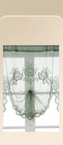 Detail view of sage green lace curtain with floral embroidery and scalloped edges