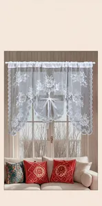 Detail of white lace coffee curtain with woven rose patterns and scalloped edges