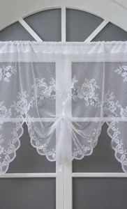 Close-up of white coffee lace curtain with floral rose patterns and scalloped edges