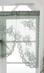 Detailed texture of green rose pattern jacquard lace curtain with wavy edges