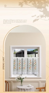 Detailed close-up of colorful leaf embroidery and ruffled edge on white cafe curtain