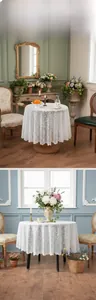 Detail of white crochet lace tablecloth featuring floral hollow patterns and wavy edges