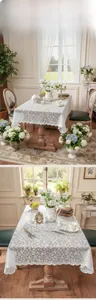 Close-up of white lace tablecloth featuring hollow floral patterns and wavy scalloped edges