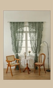 Detailed texture of dark green French lace curtain with vintage floral embroidery