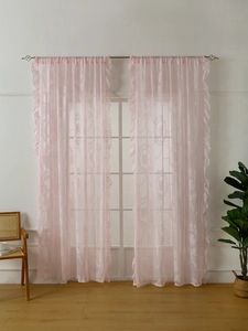 Detail of pink lace sheer curtains with floral embroidery and tiered ruffle edges