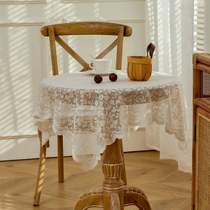 Elegant white lace round tablecloth with floral embroidery and scalloped edges for dining