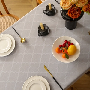 Detail of gray clover jacquard tablecloth with premium stitching and floral decor