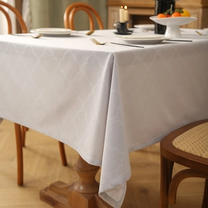 Detail of cream rectangle tablecloth with 3D Moroccan geometric texture and jacquard weave