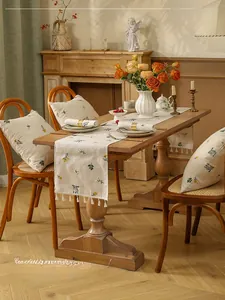 Detailed wheat embroidery on linen table runner with elegant white fringe tassels
