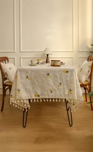 Linen tablecloth with pineapple embroidery and tassels for a cozy dining atmosphere
