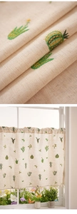 Close-up of cactus embroidery on linen cafe curtains with elegant tassel trim details