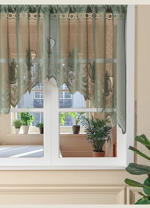 Detail of green lace café curtain with embroidered coffee pots and scalloped edge finish