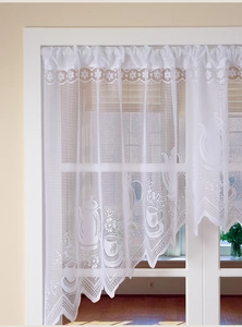 Detail of white lace cafe curtain with teapot patterns and scalloped lace edge