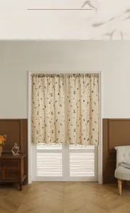 Close-up of linen door curtain featuring floral embroidery and decorative tassels