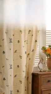 Close-up of beige linen door curtain with detailed yellow flower and lavender embroidery