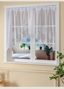 Close-up of French white lace cafe curtain with teapot pattern and scalloped edges