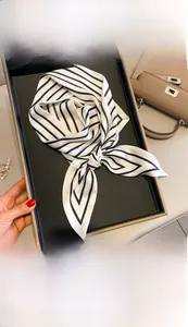 Detail of 15x150cm black and white striped imitation silk scarf tied in a bow