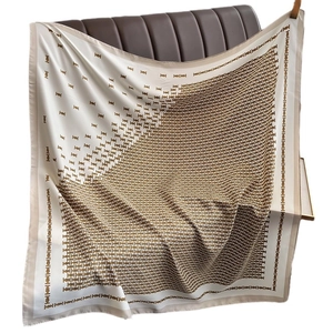 Elegant large square silk scarf featuring a cream base and golden geometric gradient patterns