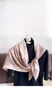 Close-up of floral twill silk scarf in beige and dusty rose with white flower patterns