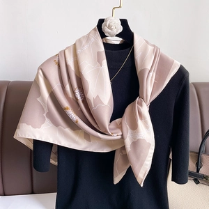 Silk feel large square scarf with brown leaf print styled on a black sweater